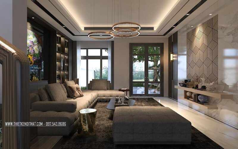 Phòng khách hiện đại sắc trầm nhưng rộng rãi, thông thoáng với cửa sổ, cửa chính kính lớn. Mẫu nội thất biệt thự đẹp